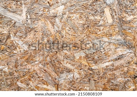 Texture of OSB boards. Drawing OSB board from wood chips. Plywood sheet with sawdust, building material, plywood with fragments of pressed sawdust.