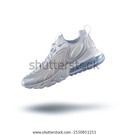 White sneaker on a white gradient background, men's fashion, sport shoe, sneakers, lifestyle,  levitation concept, street wear, product photo Royalty-Free Stock Photo #2150811211