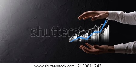 Businessman holding graph growth and increase of chart positive indicators in his business.Investment up concept.analyzing sales data and economic,strategy and planning, Digital marketing and stock.