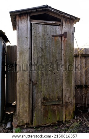 Old wooden toilet in the countryside, poverty concept. High quality photo Royalty-Free Stock Photo #2150816357