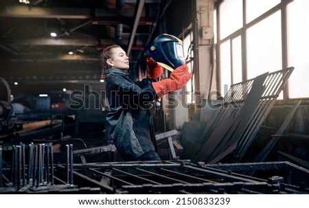 Profession gender worker, professional welder woman industrial production of metal structures.