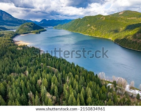 An aerial shot of a lake Stave surrounded by wild landscape in the daytime in British Columbia, Canada 