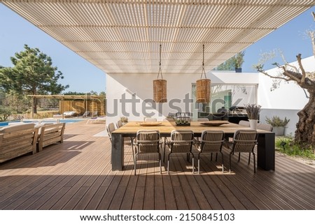 Modern villa with pool and deck with interior and exterior views Royalty-Free Stock Photo #2150845103