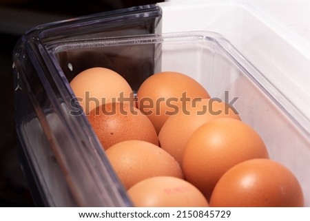Eggs in the refrigerator arranged in rows. Low temperature storage of eggs. The structure of the shell in close-up.