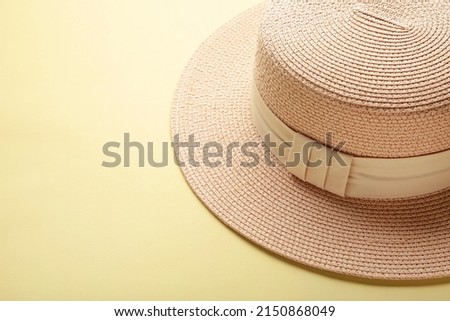Women fashion straw hat on yellow background. Space for text
