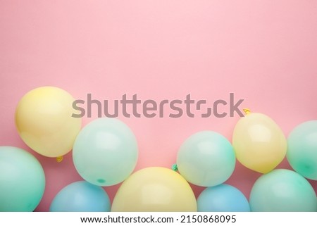 Birthday background with colorful balloons on pink background, top view. Happy birthday