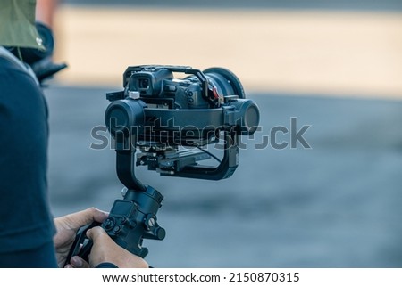 Gimbal stabilizer with mirrorless digital camera anti shake for video production cinematography Royalty-Free Stock Photo #2150870315