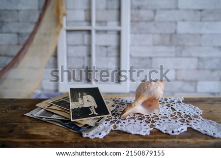 stack of vintage photos, old photography of 1940-1950 on wooden table, concept of genealogy, the memory of ancestors, family tree, genealogy, childhood memories, family archive