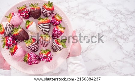 Flat lay. Step by step. Variety of chocolate dipped strawberries on a pink cake stand.