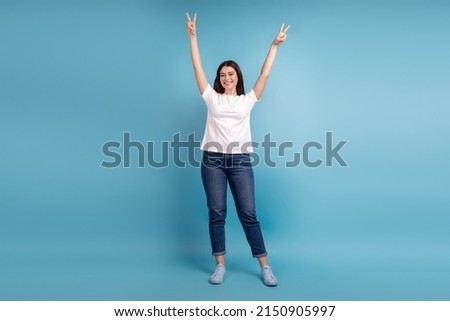Full size photo of young charming girl have fun show fingers peace v-symbol isolated over blue color background