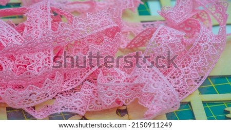 The lace ribbon is pink. This ribbon is perfect for adding fun style or modest traditional embellishment, making lovely handmade cards, and more. Openwork detail gives a charming look