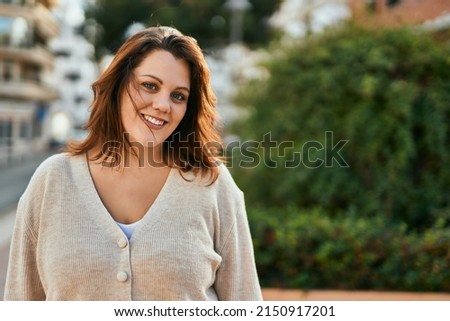 Young irish plus size girl smiling happy standing at the city. Royalty-Free Stock Photo #2150917201