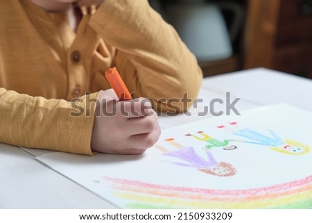 Crop child drawing LGBT family