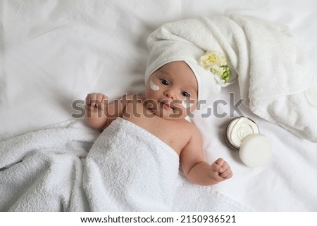 Cute little baby with cream on face, top view Royalty-Free Stock Photo #2150936521