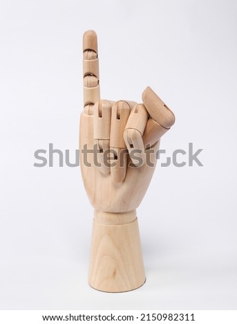 Wooden hand, little finger up on a white background