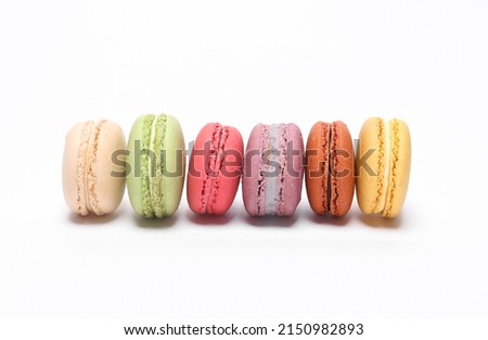 Set of colored macaroons isolated on white background. French sweet delicacy.
