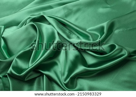 Green wave flow fabric silk. Abstract texture horizontal copy space background.