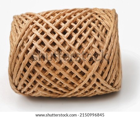 Thread ball made of natural jute fiber over white background