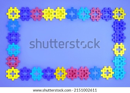 Colorful kids toys frame on blue background. Top view. Flatlay, copyspace for text. Concept World Children's Day
