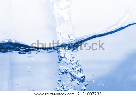 Blue water splashes and bubbles on isolated white background.