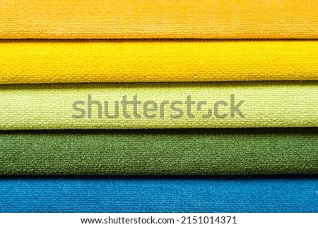 textile background in form of horizontal stripes. set of multi-colored dense fabrics of uniform texture. choice of materials in different colors. blue shades. horizontal lines. Royalty-Free Stock Photo #2151014371