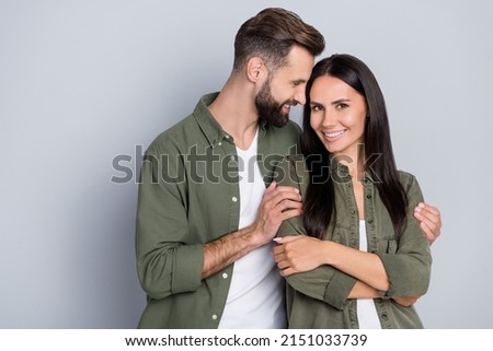 Portrait of attractive cute sweet cheerful couple cuddling enjoying romance day isolated over grey pastel color background