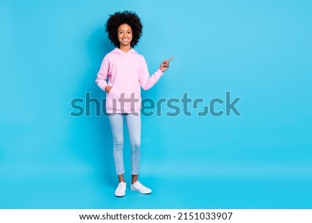 Full body photo of young lady promoter indicate finger empty space direct suggest banner isolated over blue color background