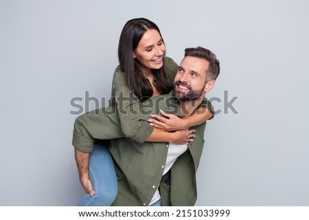 Photo of young cheerful married couple enjoy time together feelings isolated over grey color background