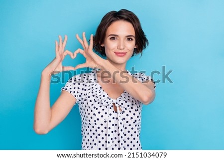 Portrait of gorgeous positive lady hands make heart figure isolated on blue color background