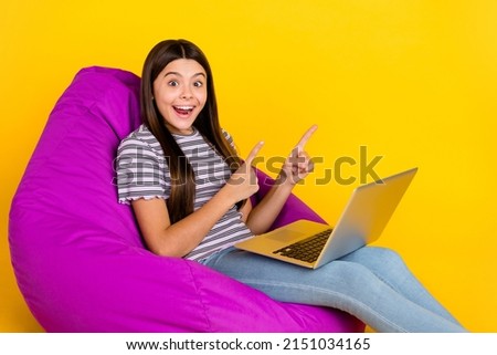 Profile side photo of young lady point fingers empty space advert suggest laptop violet chair isolated over yellow color background