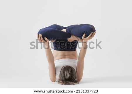 Serie of photos of young fit woman practising yoga. Studio shot on white background.	

