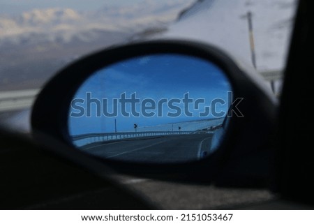 rear view mirror background mountain landscape snow