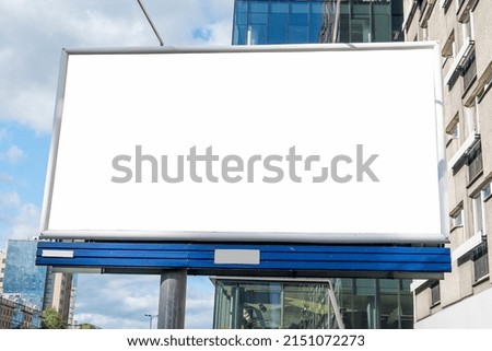 Blank white billboard for advertisement in downtown on a sunny summer day