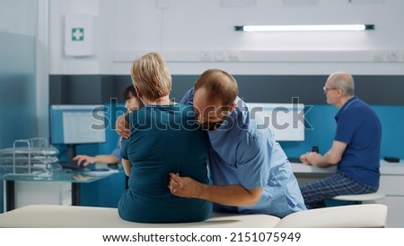 Male osteopath and old patient doing physical cracking bones exercise to help with injury recovery, assisting in cabinet. Woman attending physiotherapy procedure with specialist. Royalty-Free Stock Photo #2151075949