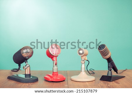 Retro old style microphones for press conference or interview front mint green background