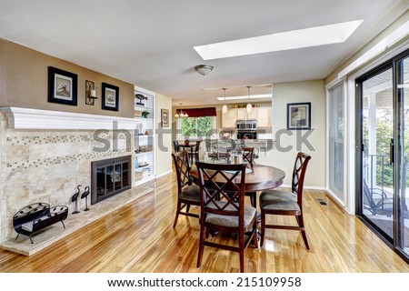 Bright dining area with fireplace and walkout deck