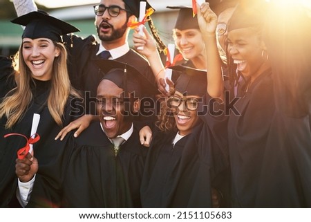 Our parents are so proud of us. Shot of a group of cheerful university students on graduation day. Royalty-Free Stock Photo #2151105683
