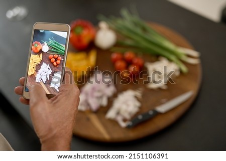 I must share this picture online. Shot of a man taking a picture of ingredients with his phone.