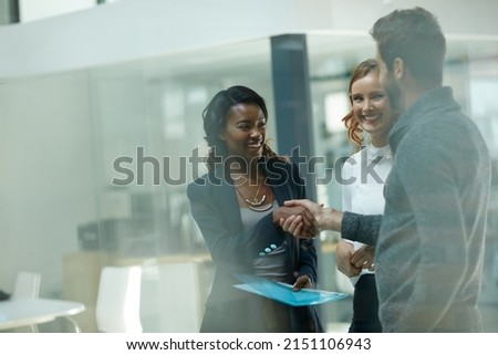 Welcoming a new member to the team. Cropped shot of businesspeople shaking hands in an office. Royalty-Free Stock Photo #2151106943