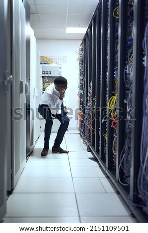 Checking if everything is in place. Cropped shot of a IT technician working and checking if all the servers are up and running.