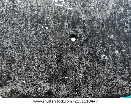 Grey black stained speckled spotted textured urban city wall grunge surface texture detail 