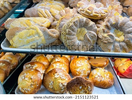 View of Mexican pan fino and picones on baking trays at a bakery. Mexican sweet bread.