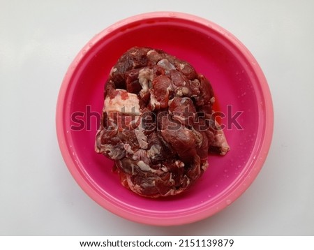 Raw beef seen from above in a bowl. on a white background. food background concept for stamina, cholesterol food, lifestyle, meal, eat, eating, cook, cooking, traditional market, dish,finance,business Royalty-Free Stock Photo #2151139879