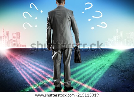 Rear view of uncertain businessman with briefcase Royalty-Free Stock Photo #215115019