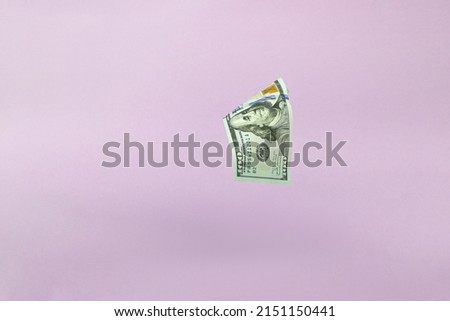 Hundred dollar bill. Falling money on pink background. American cash. Dollar banknotes flying on pink background.