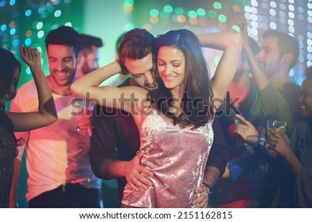 Like no one else is around. Shot of an affectionate young couple dancing on a crowded dance floor in a nightclub. Royalty-Free Stock Photo #2151162815