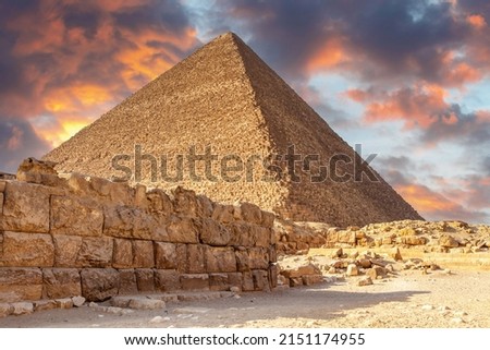 One of the pyramids of Giza, Cairo, Egypt at sunset. Built by the Pharaohs as a tomb and passage to the afterlife, where they believed they would be Gods. Royalty-Free Stock Photo #2151174955