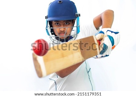 Portrait of boy hitting a shot During a Cricket Game