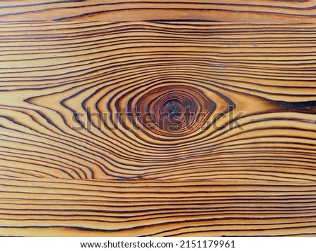 Wooden background or texture. Burnt wood with knots. High quality photo Royalty-Free Stock Photo #2151179961