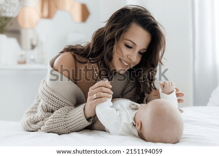 mother and lovely baby and daughter indoor at home